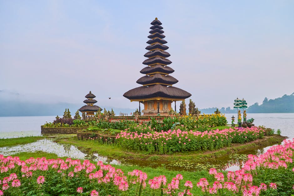Beautiful Ulun Danu Beratan Temple in Bali, surrounded by colorful flowers and a serene lake.
